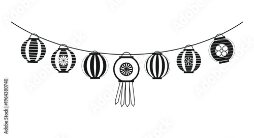 Traditional Japanese paper lanterns with various patterns hanging on a string for a festive summer decoration or matsuri event.