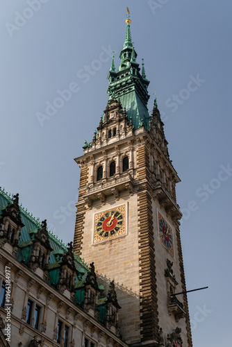 HAMBURG, GERMANY - MARCH 07, 2026: Low angle view of the historic Hamburg Rathaus clock tower with green copper roof and ornate neo-renaissance facade