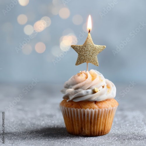 Festive cupcake with star candle against sparkling background