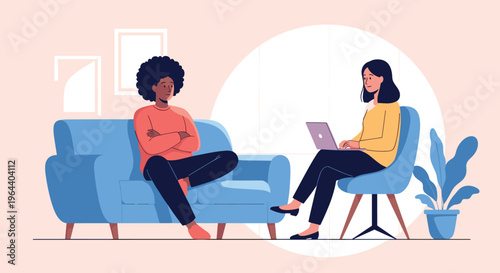 Professional therapy session with a black woman sitting on a sofa and a counselor using a laptop for documentation.