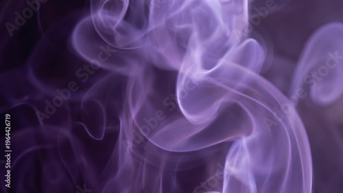 Purple powder explosion forming abstract vibrant pattern concept. Abstract purple smoke swirling on dark background with soft glowing light effect