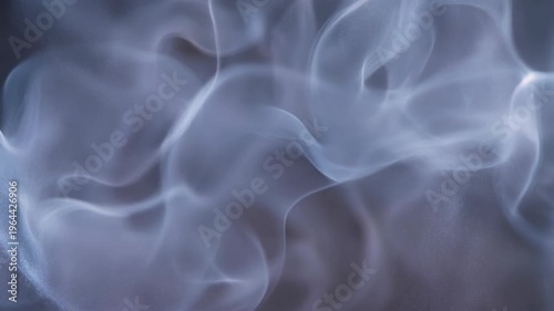 Purple powder explosion forming abstract vibrant pattern concept. Abstract swirling blue smoke texture on dark background for artistic and mysterious effects