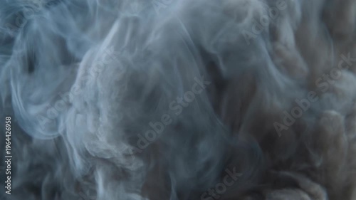 Purple powder explosion forming abstract vibrant pattern concept. Abstract swirling blue smoke texture with dark background for mystical and atmospheric design