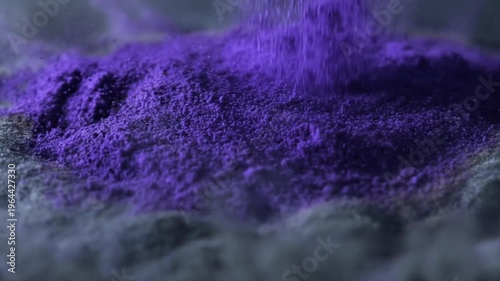 Purple powder explosion forming abstract vibrant pattern concept. Vibrant purple powder explosion with dynamic motion on dark surface for creative abstract background
