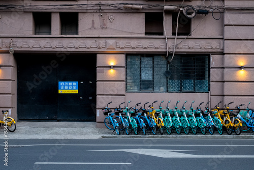 Photography Shared bicycles parked in a traditional Shanghai lane, daily life in a Chinese a