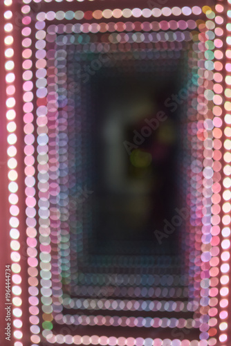 Abstract background of a colorful bokeh light tunnel.