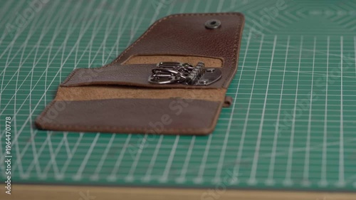 A very detailed close-up focusing on the key holder, which was crafted by a master craftsman from genuine brown leather.