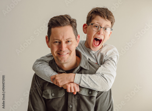 Father and son having fun laughing together isolated on white background