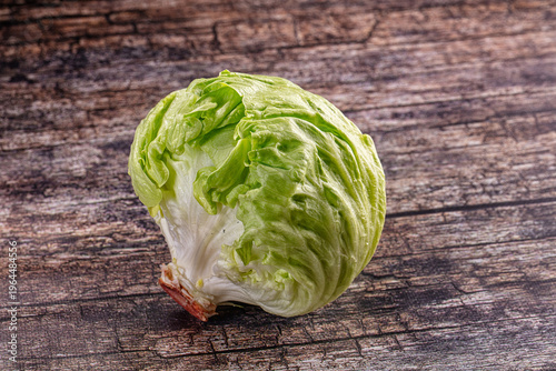 Valokuva Fresh head of iceberg lettuce on a rustic dark wooden table background