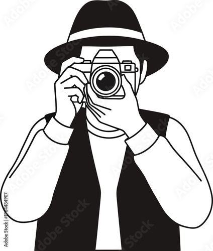 Photographer in fedora hat takes picture through vintage camera lens directly.