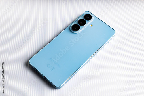 Back view of blue Samsung Galaxy S24 smartphone with triple camera