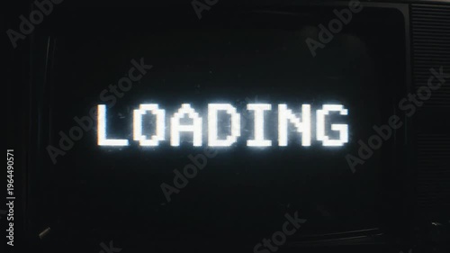 Medium shot. loading 8 bit retro screen on vintage CRT monitor in dark room. Analog static, glitch, scanlines, flickering light. Technology, gaming, retro.