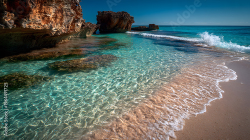 A picturesque coastal scene of turquoise water, a sandy beach, and rugged cliffs, all bathed in the warm embrace of sunlight.