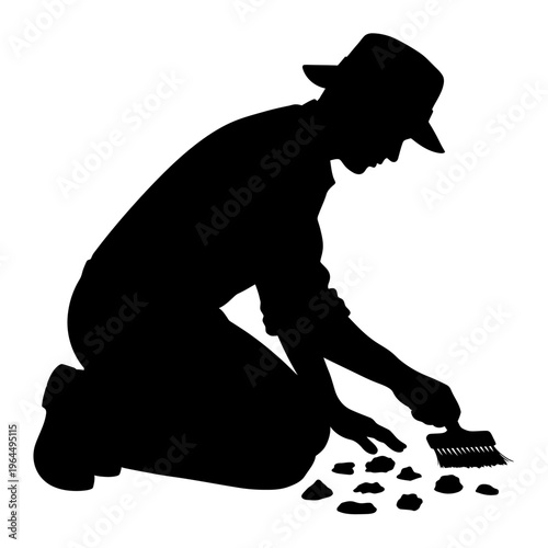 Silhouette of an Archaeologist Carefully Examining Ancient Artifacts.