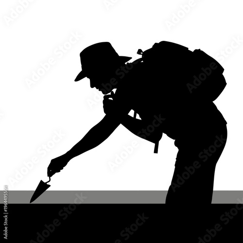 Silhouette of an Archaeologist Excavating with a Trowel Outdoors.