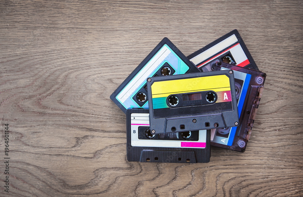 Fototapeta premium audio cassettes lying on a wooden background