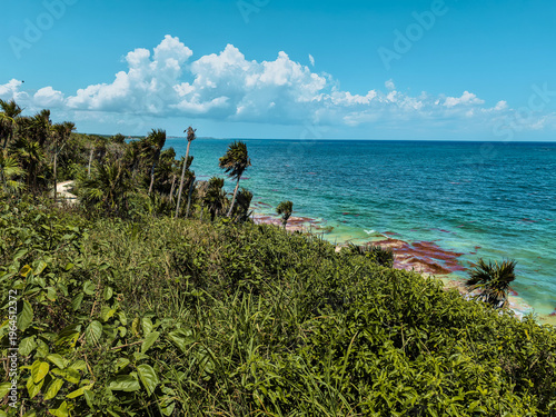 Tropical coastline of Tulum with lush jungle and turquoise Caribbean Sea in Mexico.