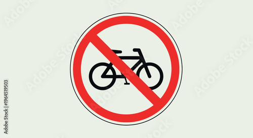 A circular red sign with a bicycle crossed out. Sign is against a light-colored backdrop