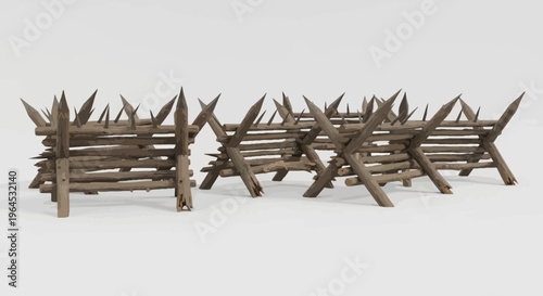 Line of wooden obstacles, each with pointed stakes, sitting on a plain, light surface