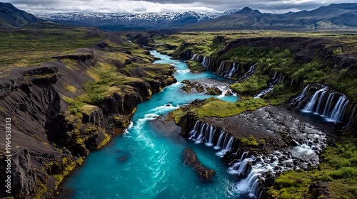River with waterfalls in mountainous landscape