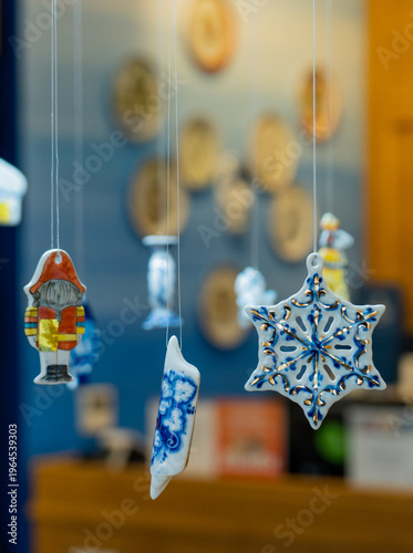 Porcelain toys hang on strings.