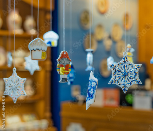 Porcelain toys hang on strings.