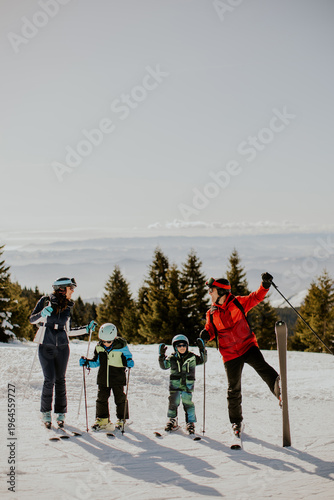 Family enjoys skiing on a snowy mountain during daytime in winter