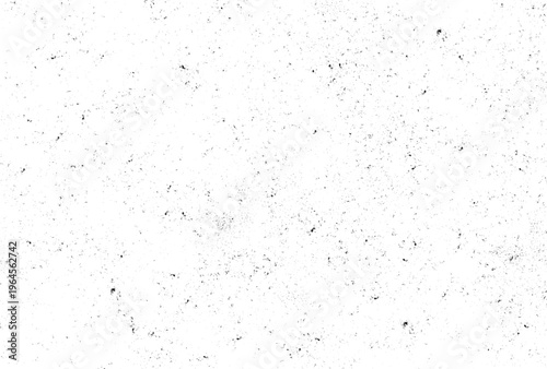 Monochromatic speckled overlay featuring countless tiny dark particles dispersed unevenly over a clean white canvas, ideal for adding subtle grunge or aged effects to various visuals