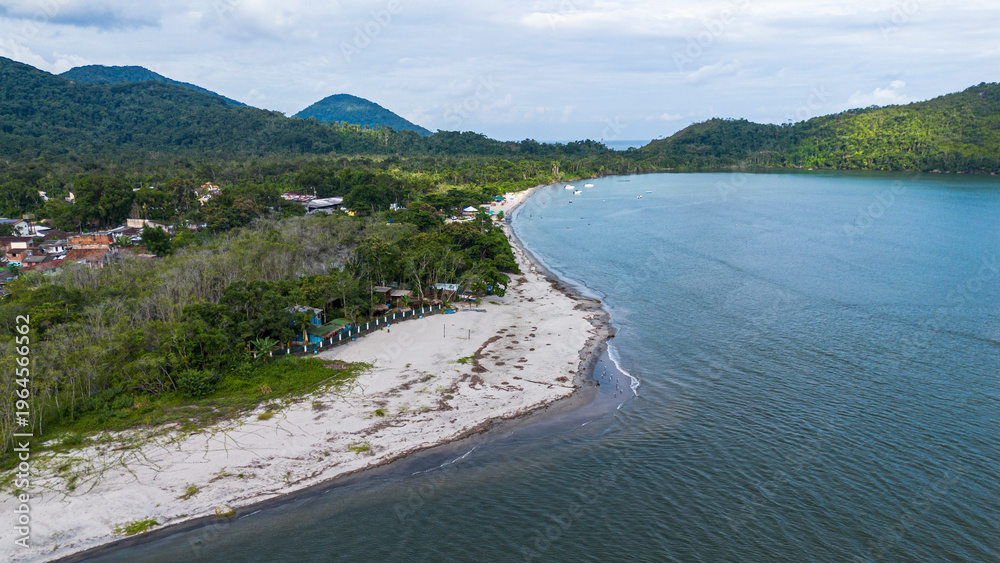 Obraz premium Aerial drone view of Barra Seca Beach in Ubatuba, Brazil. Estuary where the river meets the ocean, sandy coastline with lush tropical rainforest and turquoise water in Sao Paulo state.
