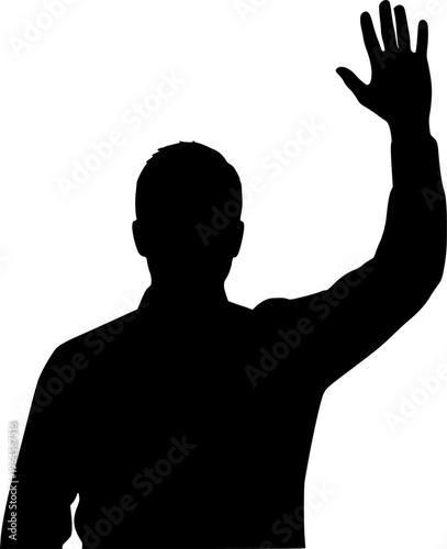 A man is standing in front of a white background. He is wearing a suit and is holding his fist up in the air

