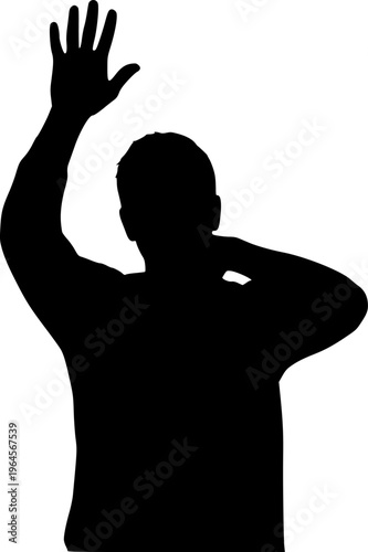 A man is standing in front of a white background. He is wearing a suit and is holding his fist up in the air
