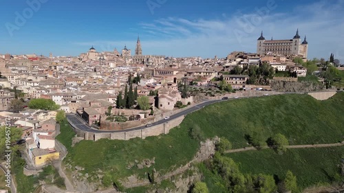 Aerial drone pullback from Toledo skyline with Alcazar and Cathedral, historic city Spain