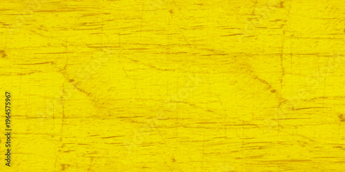 Vivid yellow wood texture with natural grain and distressed aged surface; bright golden timber background for design