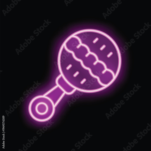 Vibrant pink neon sign depicting a baby rattle, emitting a warm and inviting glow