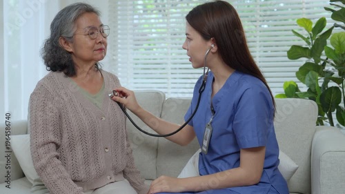 Caregiver elderly care home nurse healthcare patient stethoscope support checkup gentle moment of trust while nurse listens heartbeat in living room, warm bond grows during routine medical visit