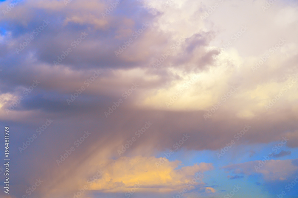Fototapeta premium Dramatic sky with colorful clouds and sunbeams breaking through the atmosphere