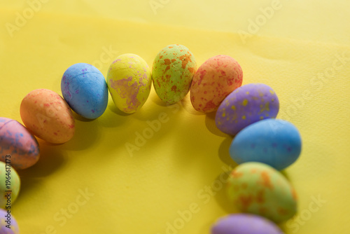 Beautiful decorated Easter eggs on a yellow background and the inscription Easter