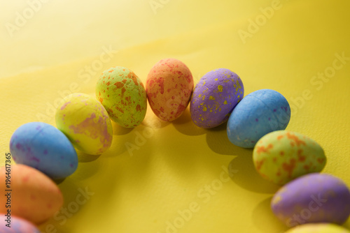 Beautiful decorated Easter eggs on a yellow background and the inscription Easter
