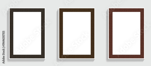 Three empty picture frames with dark wood grain borders