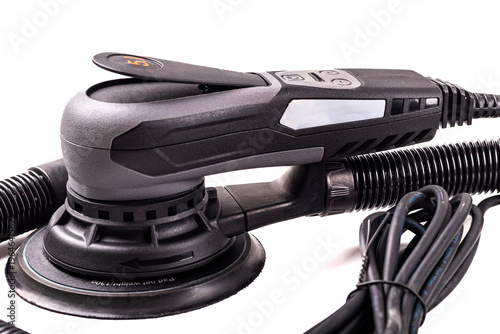 Orbital sander is shown on a white background with a long power cord and a dust collection feature for woodworking tasks