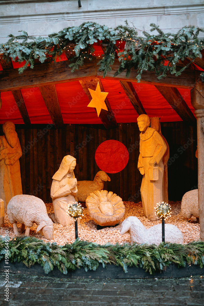 Fototapeta premium Wooden nativity scene with figures and sheep decoration