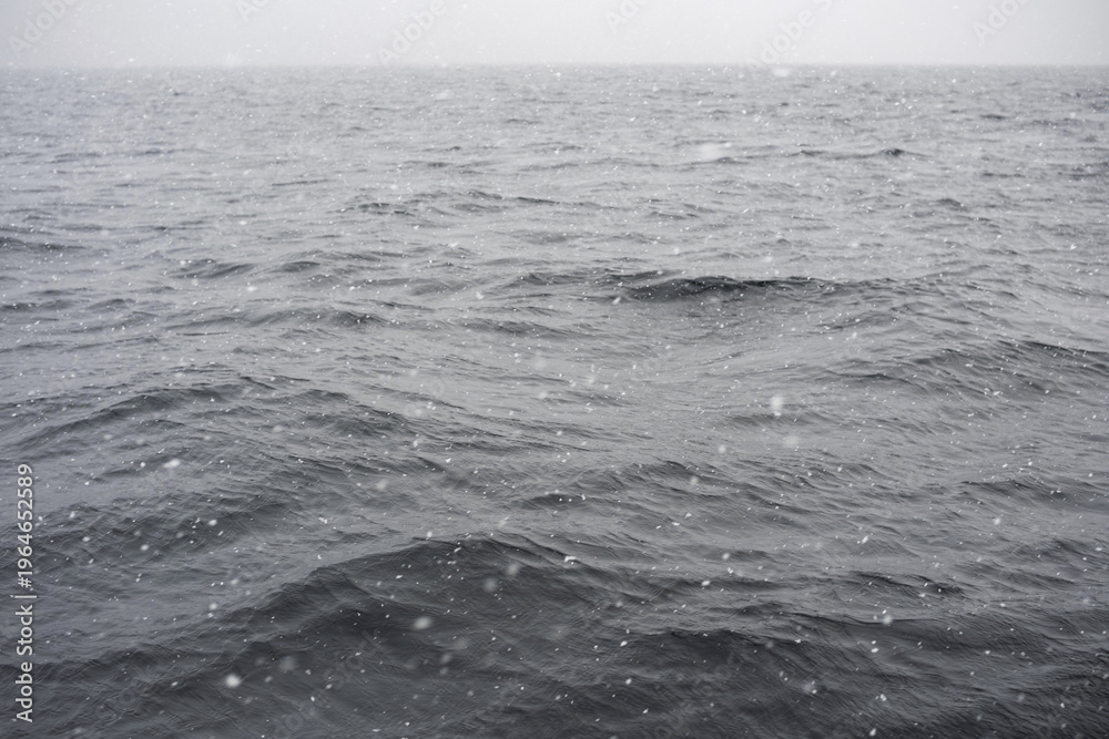 Fototapeta premium Königssee lake with gentle waves and falling snow