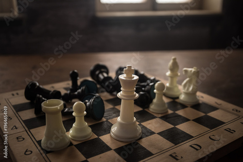 Chess board game concept of business ideas and competition and strategy ideas concep. Chess figures on a dark background with smoke and fog. Selective focus