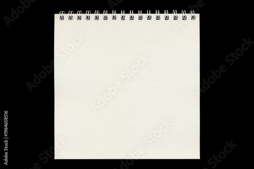 Blank spiral notepad sheet in vertical format on black background