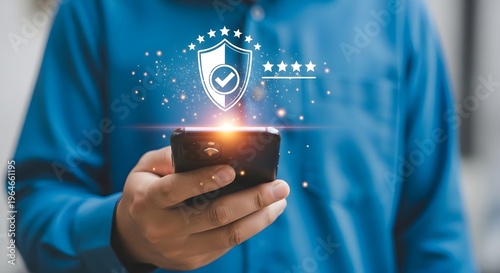 Person holding a smartphone with a shield icon and stars above it.