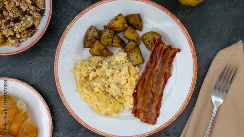 A Rotating Plate of Scrambled Eggs with Bacon and Hash Brown Potatoes