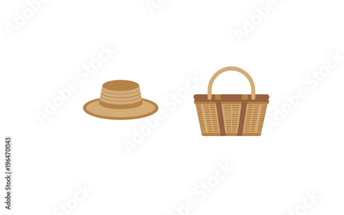 A wicker picnic basket and hat on a background.