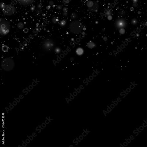 Silver glitter dust floats softly in a dark transparent space. Tiny sparkling particles create a magical glow. Perfect for holiday and festive designs.