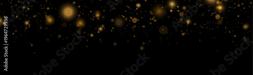 Soft glowing sparkles form an abstract light pattern. Golden tones dominate the elegant composition. The visual effect is dreamy and refined.