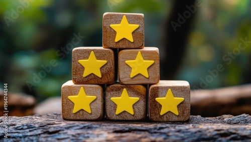 Wooden cubes with yellow stars on them, stacked in a pyramid shape against a blurred background.